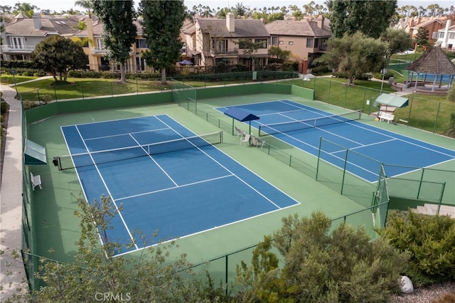 view of tennis court with basketball hoop