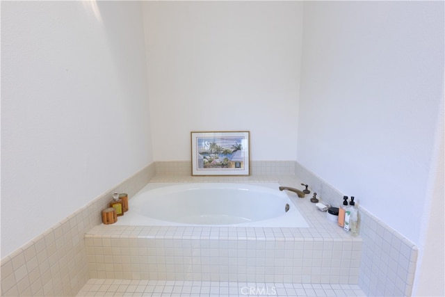 bathroom with a relaxing tiled tub