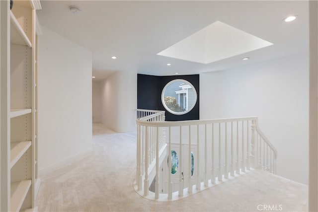 corridor with light colored carpet