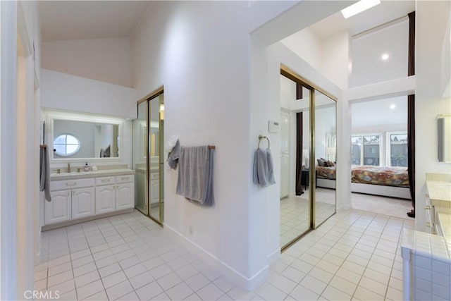 6218 Tobruk Ct, Long Beach, CA 90803 - full bath featuring connected bathroom, vanity, tile patterned floors, baseboards, and a high ceiling
