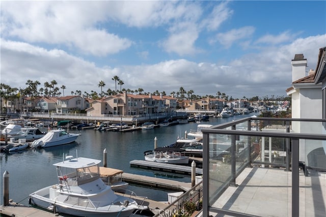 dock area featuring a water view and a balcony