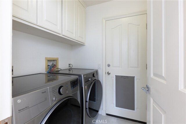 laundry room with cabinets and separate washer and dryer