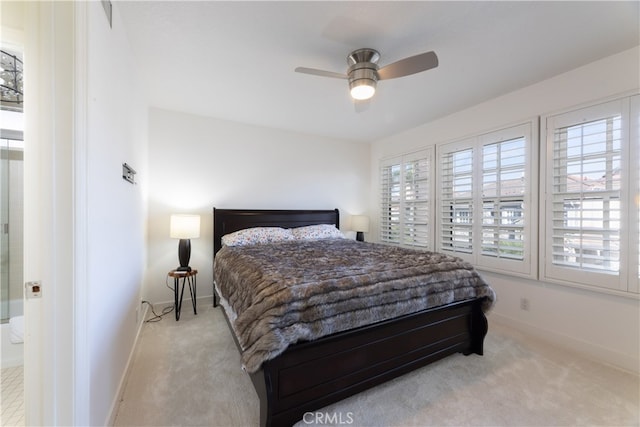 bedroom with multiple windows, light colored carpet, and ceiling fan