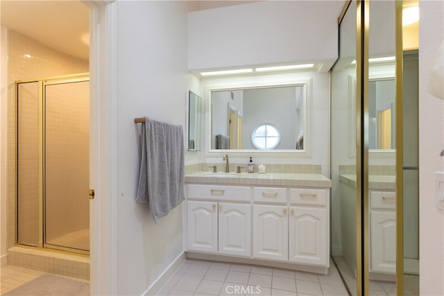 bathroom with vanity, tile patterned flooring, and an enclosed shower