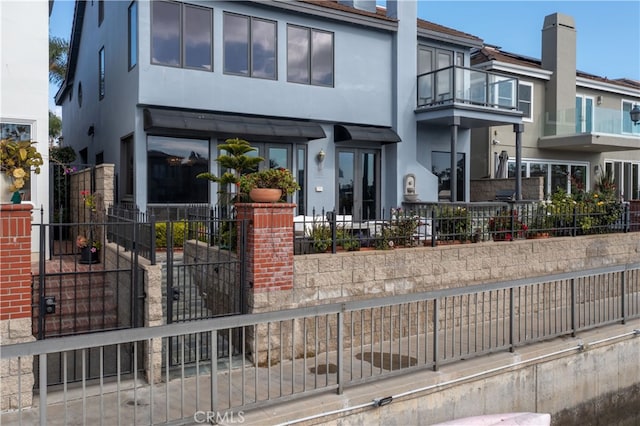 view of front of house featuring a balcony