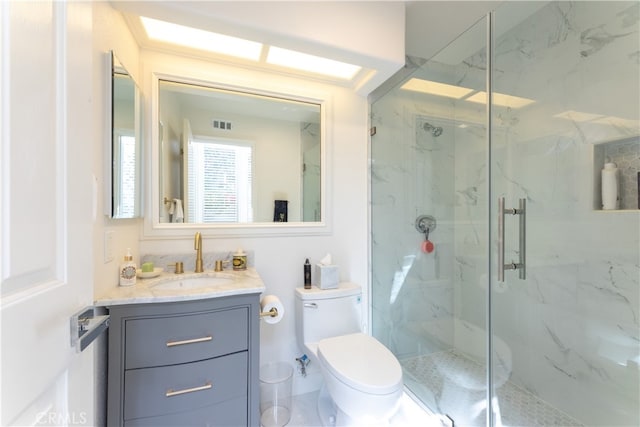 bathroom with vanity, toilet, and an enclosed shower