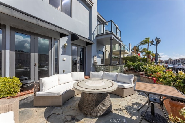 view of patio with a balcony and outdoor lounge area