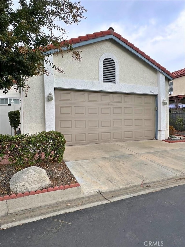 mediterranean / spanish home with a garage