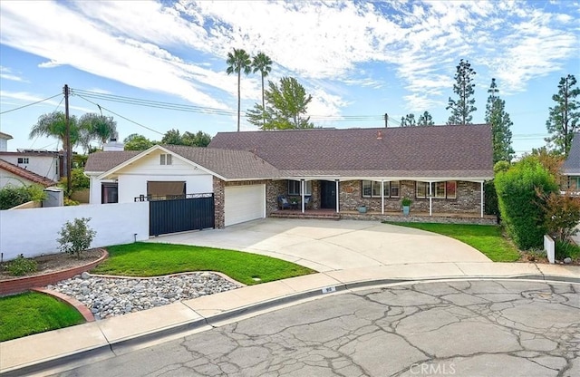 ranch-style home with a front lawn and a garage