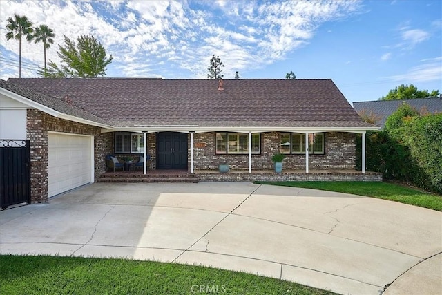 ranch-style home with a porch and a garage