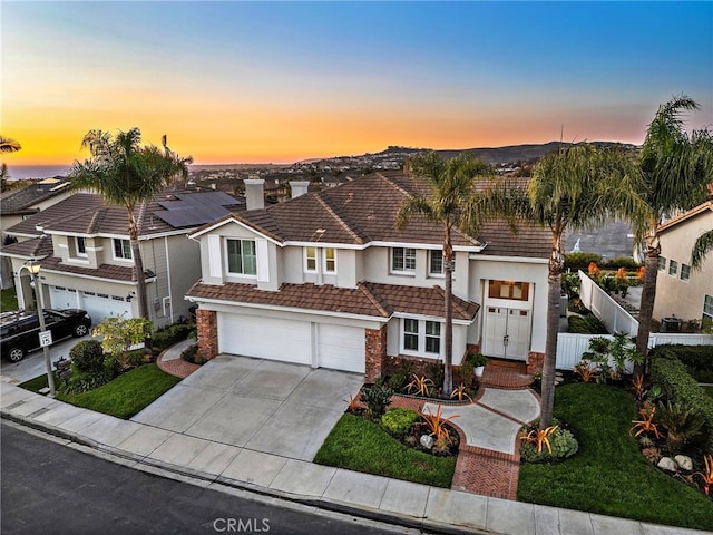 view of front of house with a garage and a yard