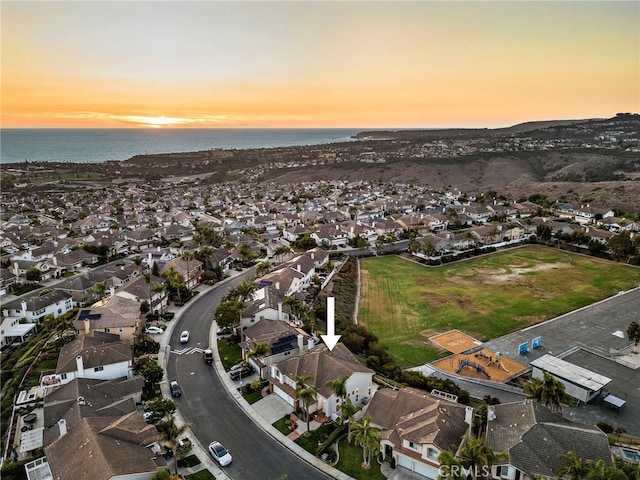 aerial view at dusk with a water view