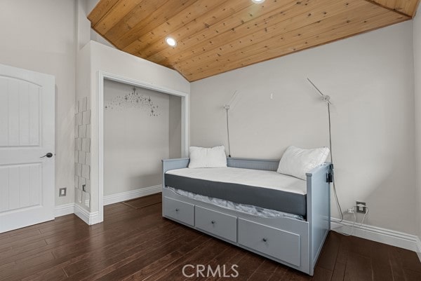 bedroom with lofted ceiling, dark hardwood / wood-style floors, and wooden ceiling