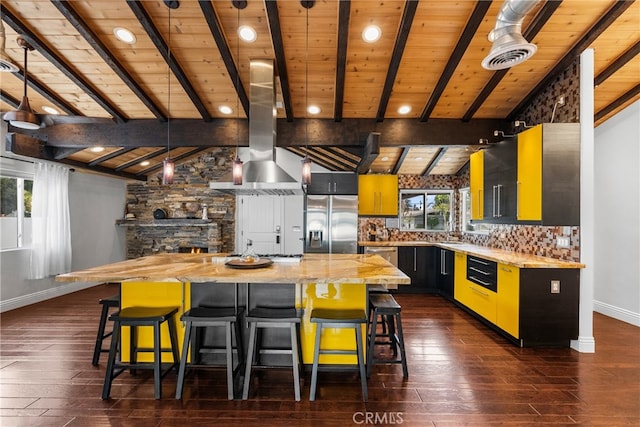 kitchen with a wealth of natural light, a center island, stainless steel appliances, and dark hardwood / wood-style floors