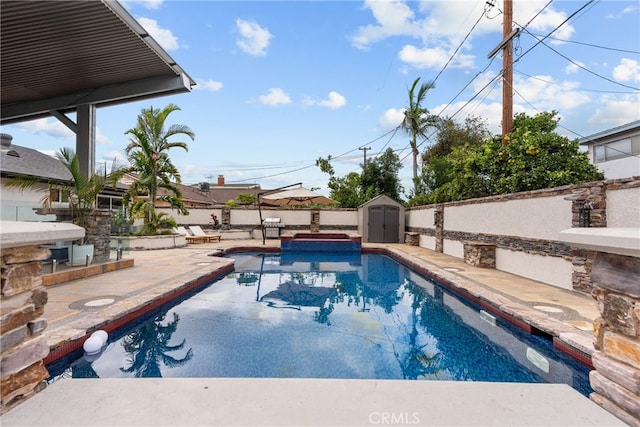 view of pool featuring a patio and a storage unit