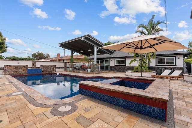 view of pool featuring a patio and an in ground hot tub