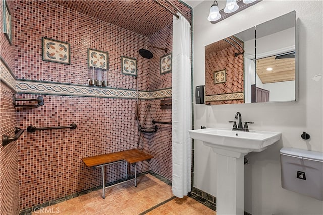 bathroom with toilet and tile walls