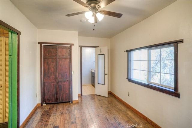 unfurnished bedroom with hardwood / wood-style floors and ceiling fan