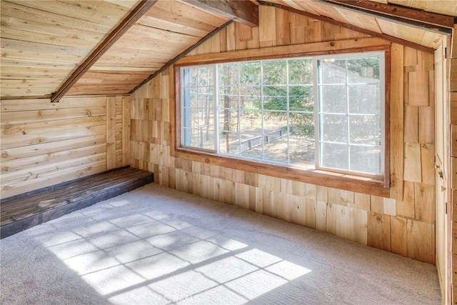 bonus room with carpet floors, lofted ceiling with beams, and wood walls