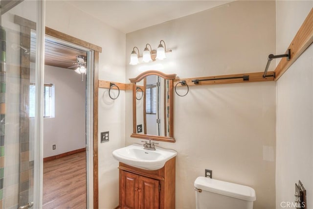 bathroom featuring vanity, ceiling fan, hardwood / wood-style flooring, and toilet