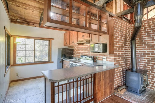 kitchen featuring wooden ceiling, light tile patterned floors, a wood stove, range with electric stovetop, and kitchen peninsula