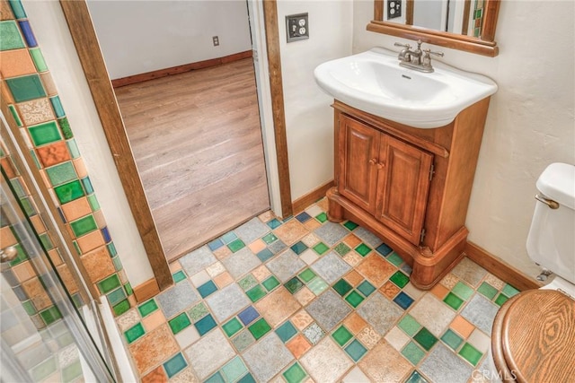 bathroom featuring vanity, wood-type flooring, and toilet