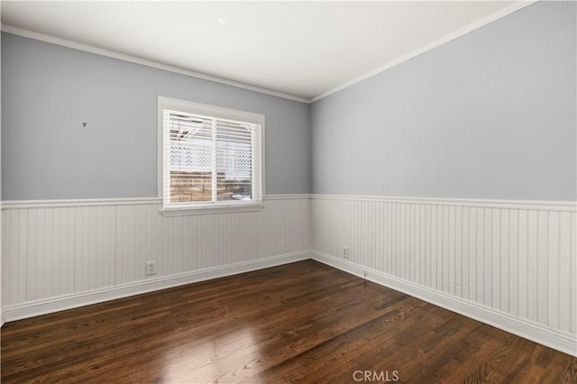 empty room featuring dark hardwood / wood-style floors and ornamental molding