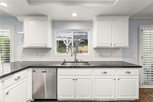 kitchen with decorative backsplash, stainless steel dishwasher, sink, dark hardwood / wood-style floors, and white cabinetry