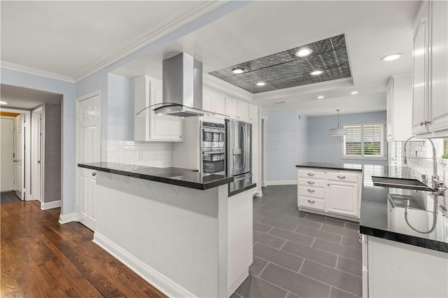 kitchen featuring white cabinetry, kitchen peninsula, sink, and extractor fan