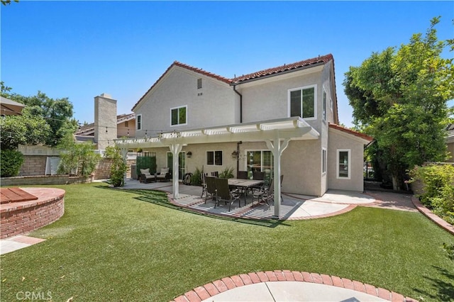 rear view of house with a pergola, a patio area, and a yard