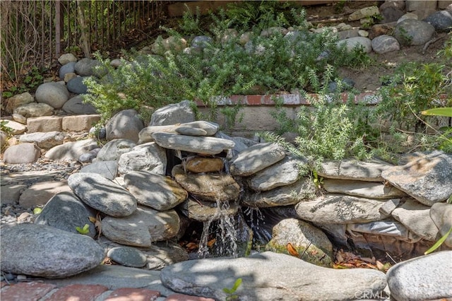 exterior details featuring a garden pond