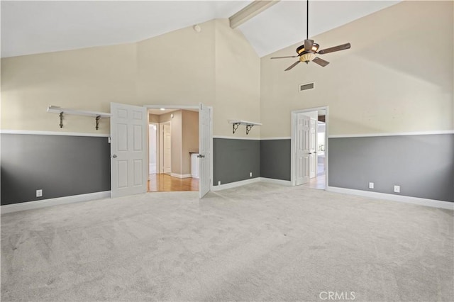 interior space featuring beamed ceiling, ceiling fan, and high vaulted ceiling