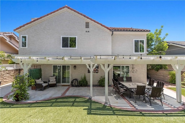 rear view of property with a patio, a pergola, and a lawn