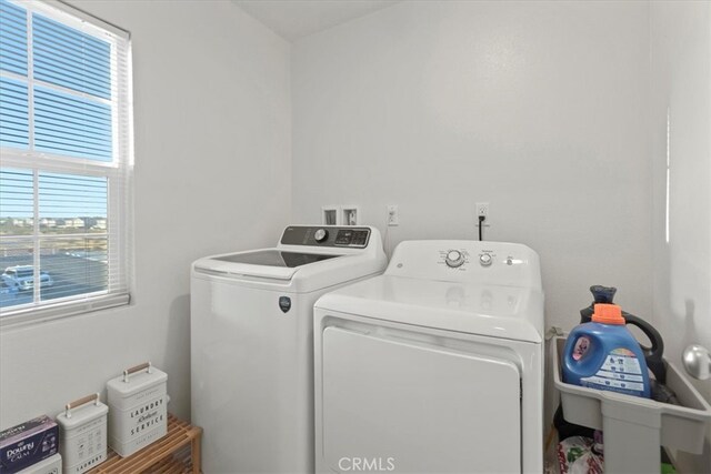 laundry area featuring a healthy amount of sunlight and washer and clothes dryer