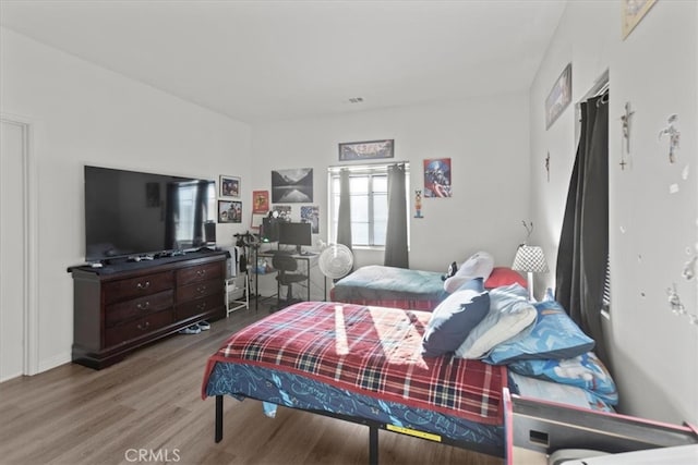 bedroom with hardwood / wood-style flooring