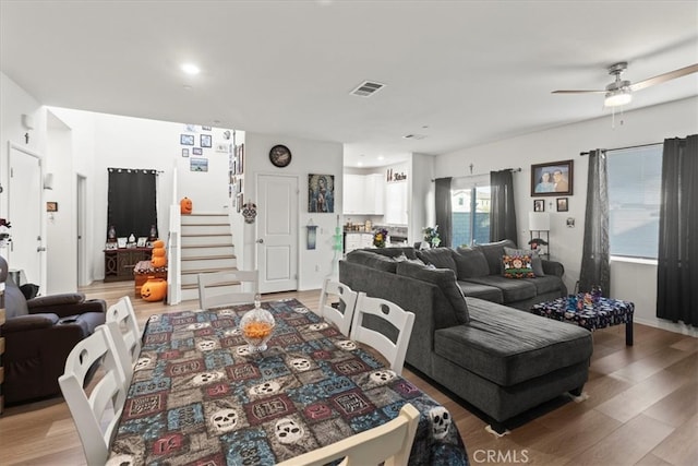 living room with hardwood / wood-style flooring and ceiling fan