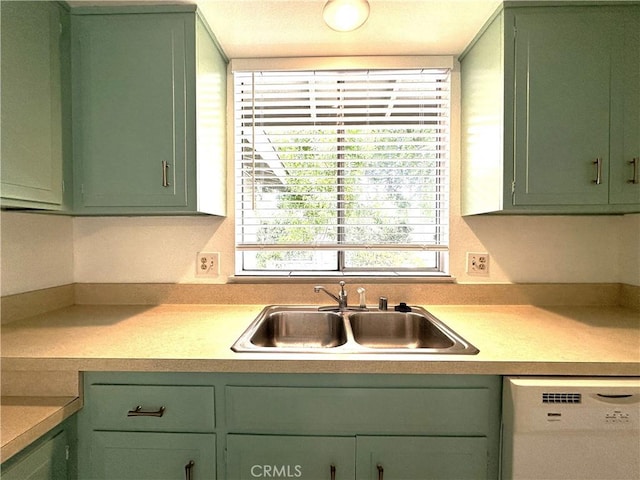 kitchen featuring dishwasher, green cabinets, and sink