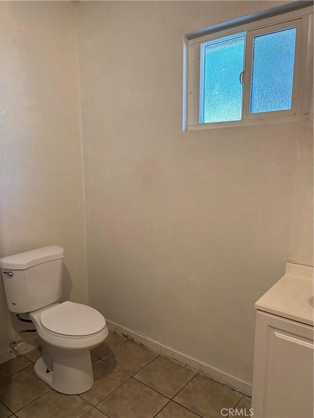 bathroom featuring toilet, tile patterned floors, and vanity