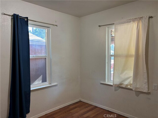 spare room featuring dark hardwood / wood-style floors