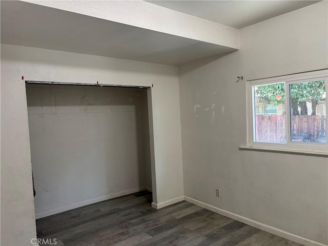 unfurnished bedroom with dark hardwood / wood-style flooring