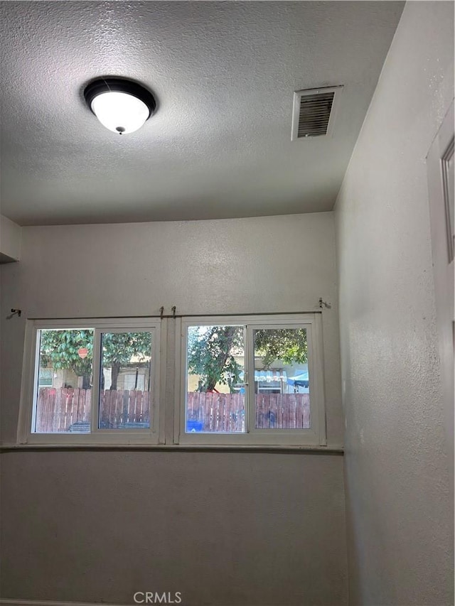 empty room with a textured ceiling