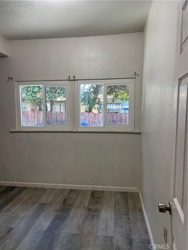 spare room featuring dark hardwood / wood-style floors