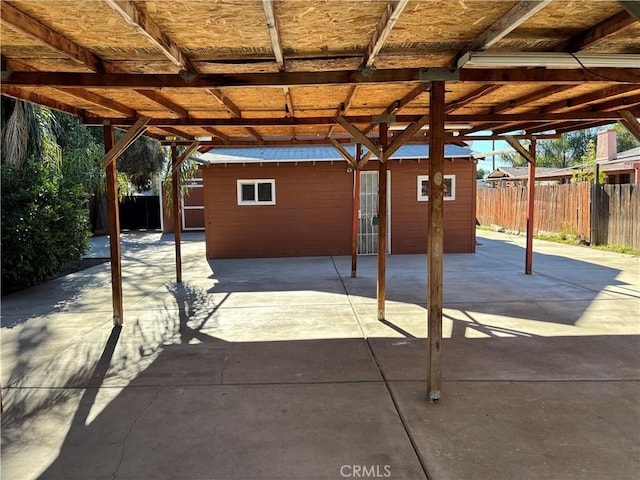 view of patio featuring a storage unit