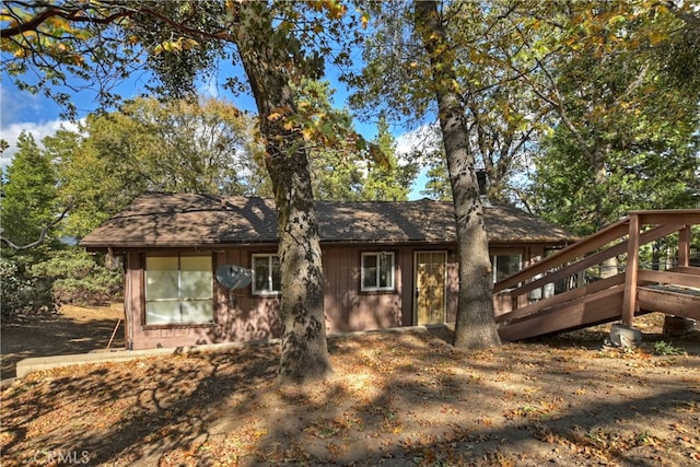 back of property featuring a wooden deck