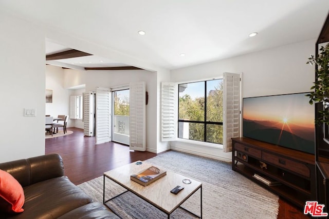 living room with dark hardwood / wood-style floors and beamed ceiling