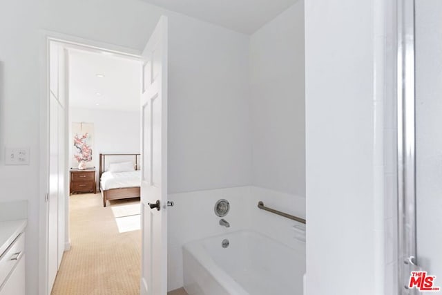 bathroom with a tub to relax in and vanity