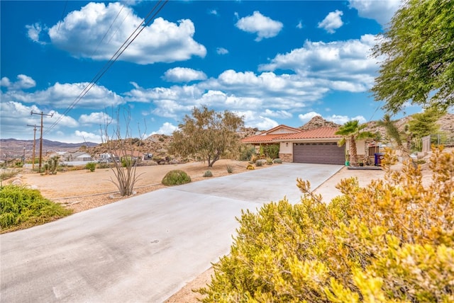 view of front of home with a mountain view and a garage