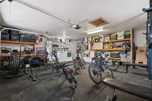 garage with a garage door opener, water heater, and washer and dryer