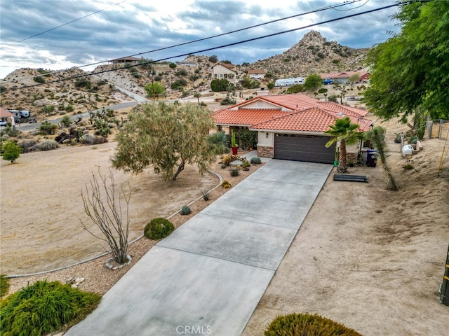 view of front of home with a mountain view and a garage