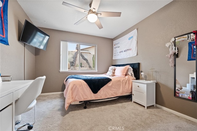 bedroom with ceiling fan and light carpet